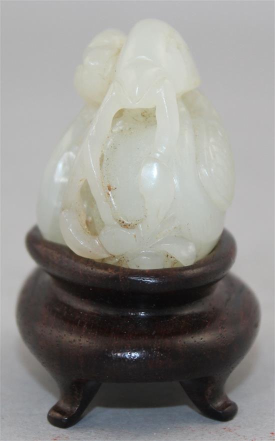 A Chinese white jade carving of two mandarin ducks, 18th / 19th century, 4.8cm., wood stand